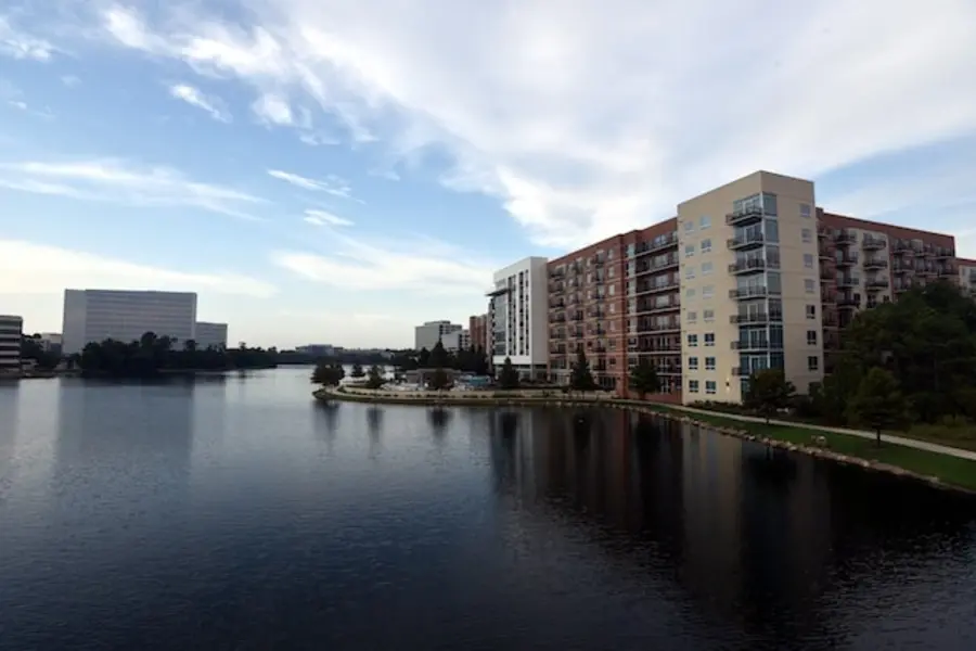 View of a quiet little lake surrounded by buildings in the Woodland area of Houston, Texas